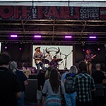 People on a plaza watching an outdoor concert